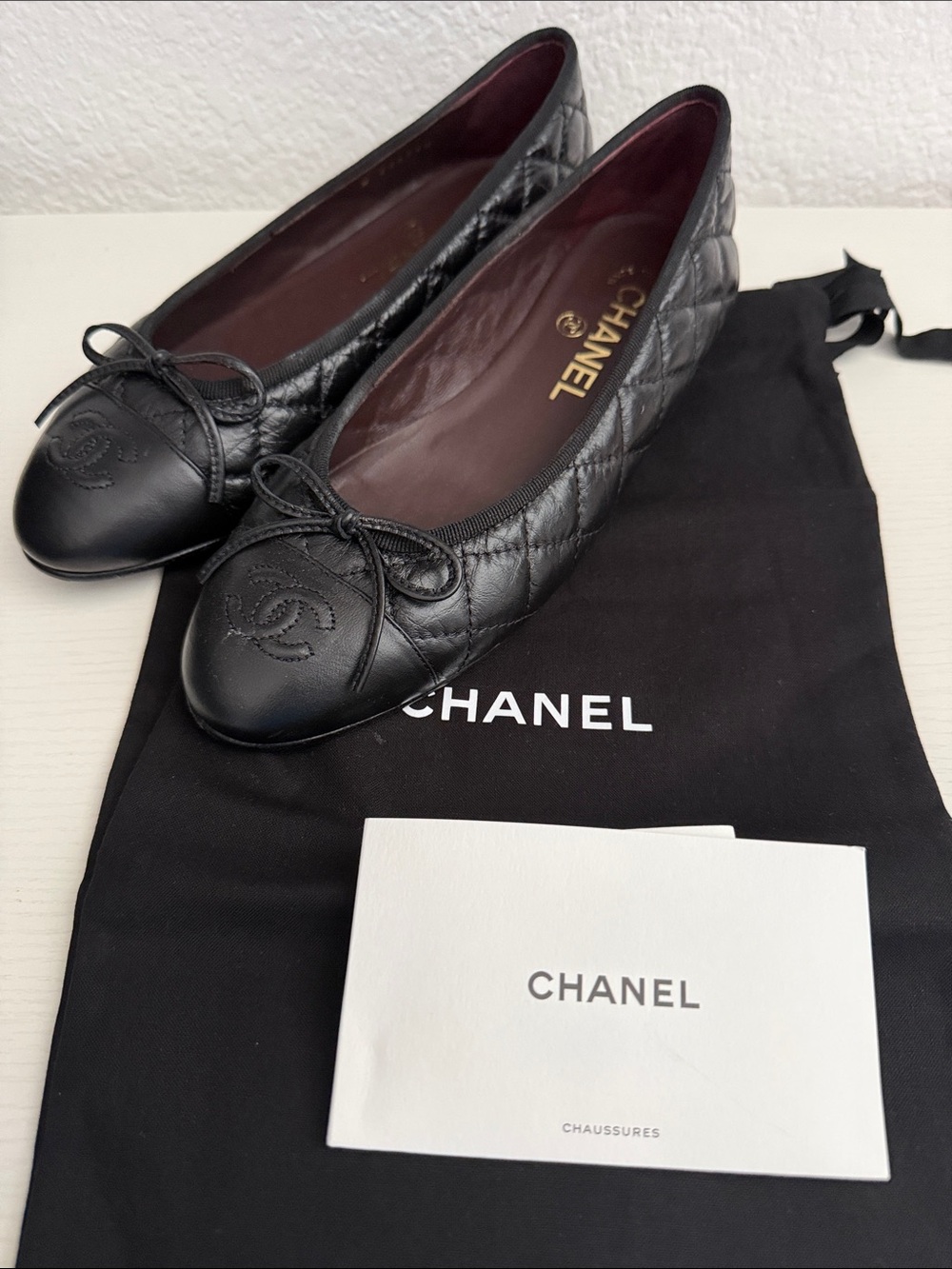 CHANEL Black Quilted Leather Ballet Flats with Logo Cap Toe